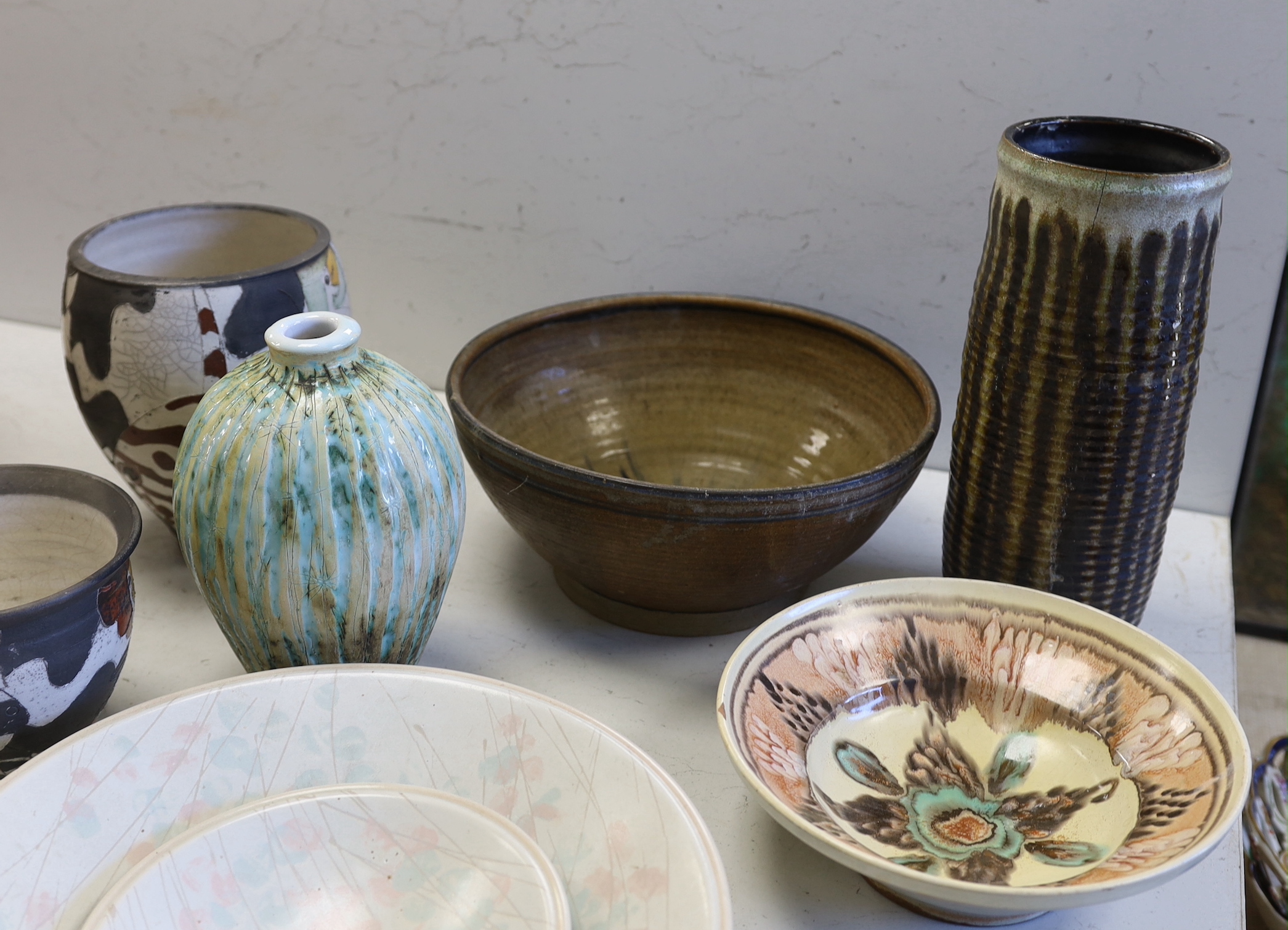 A collection of studio pottery including a Kenneth Annat Bemersyde Scottish vase, two graduated bowls and a jardiniere incised with birds, the largest 28cm high